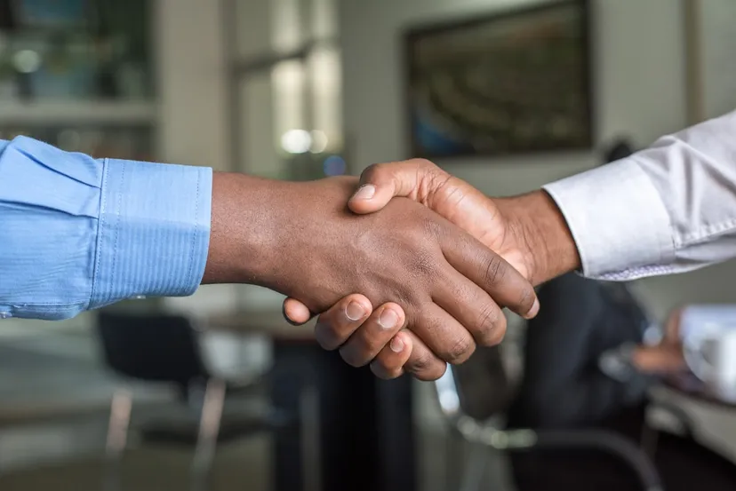 Two people shaking hands on a handover
